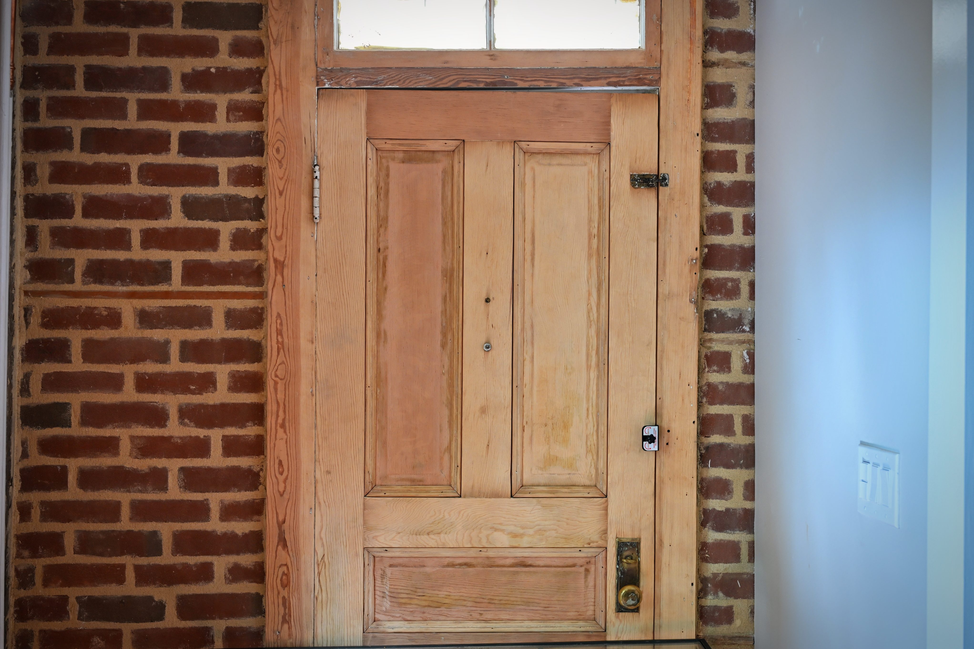 Whitmore properties — interior door in brick wall