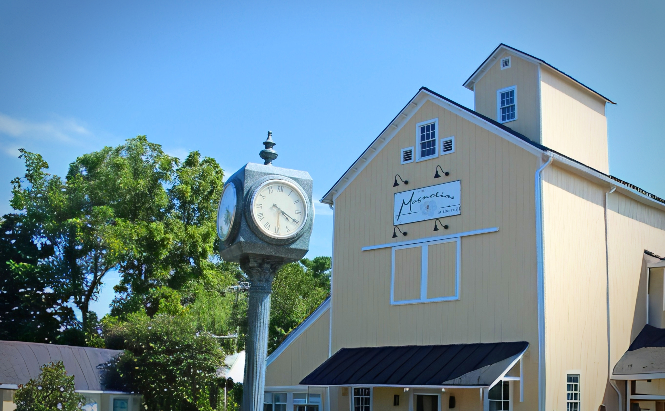 The street clock and sign of Magnolias at the Mill, Leesburg, Virginia.