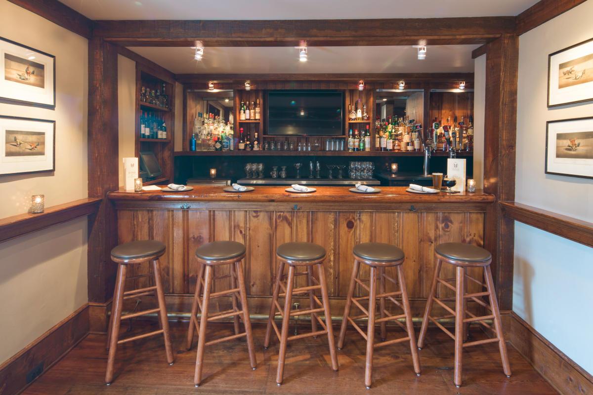 The pine service bar — said to have been built from a Civil War field operating table.
