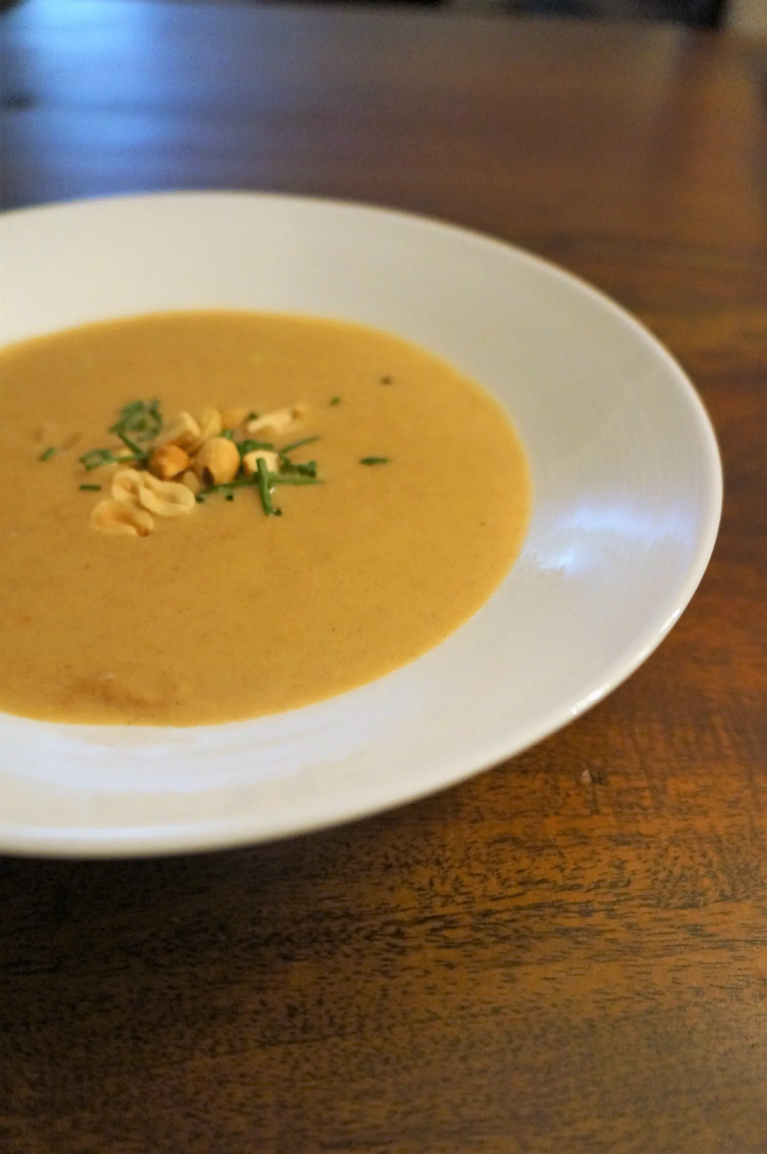 The peanut soup — a Virginia tradition with roots in West African cooking, served beside a stone hearth.