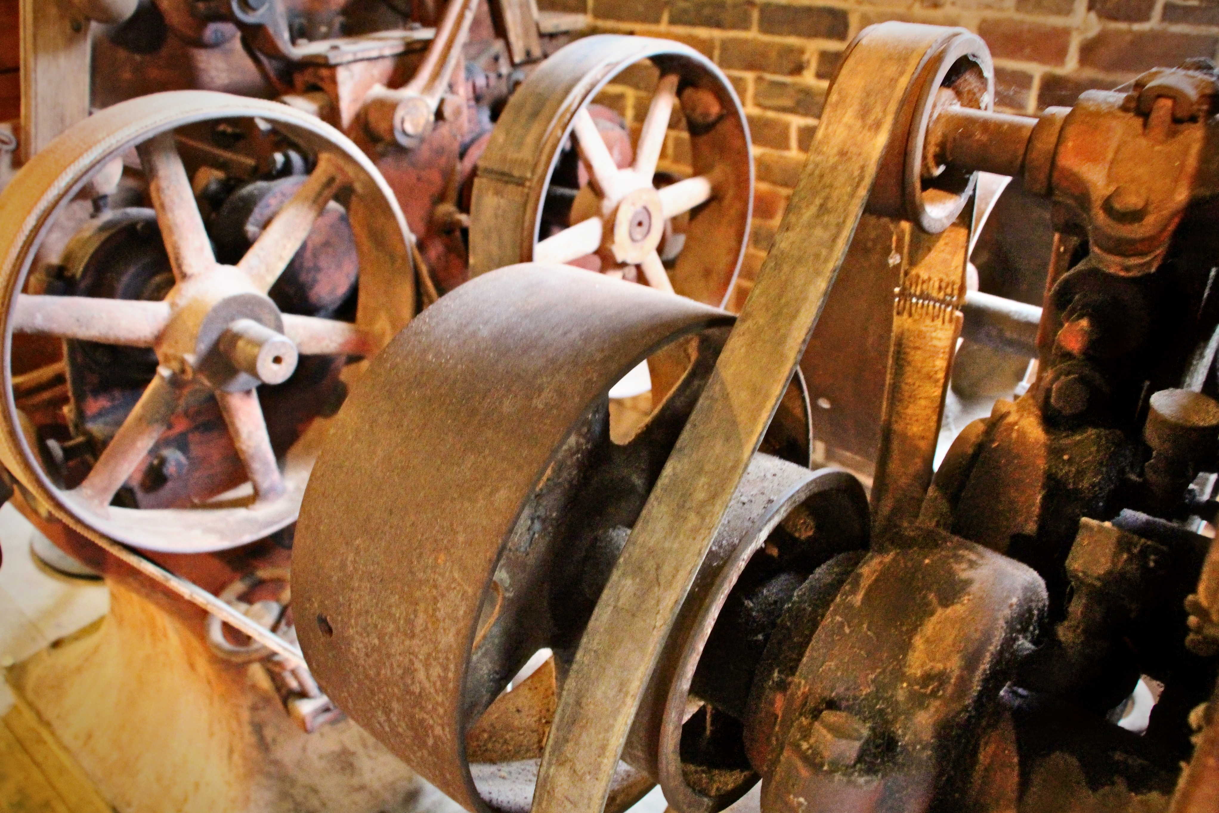 Iron wheels and a flat drive belt — the transmission of water’s power into work.