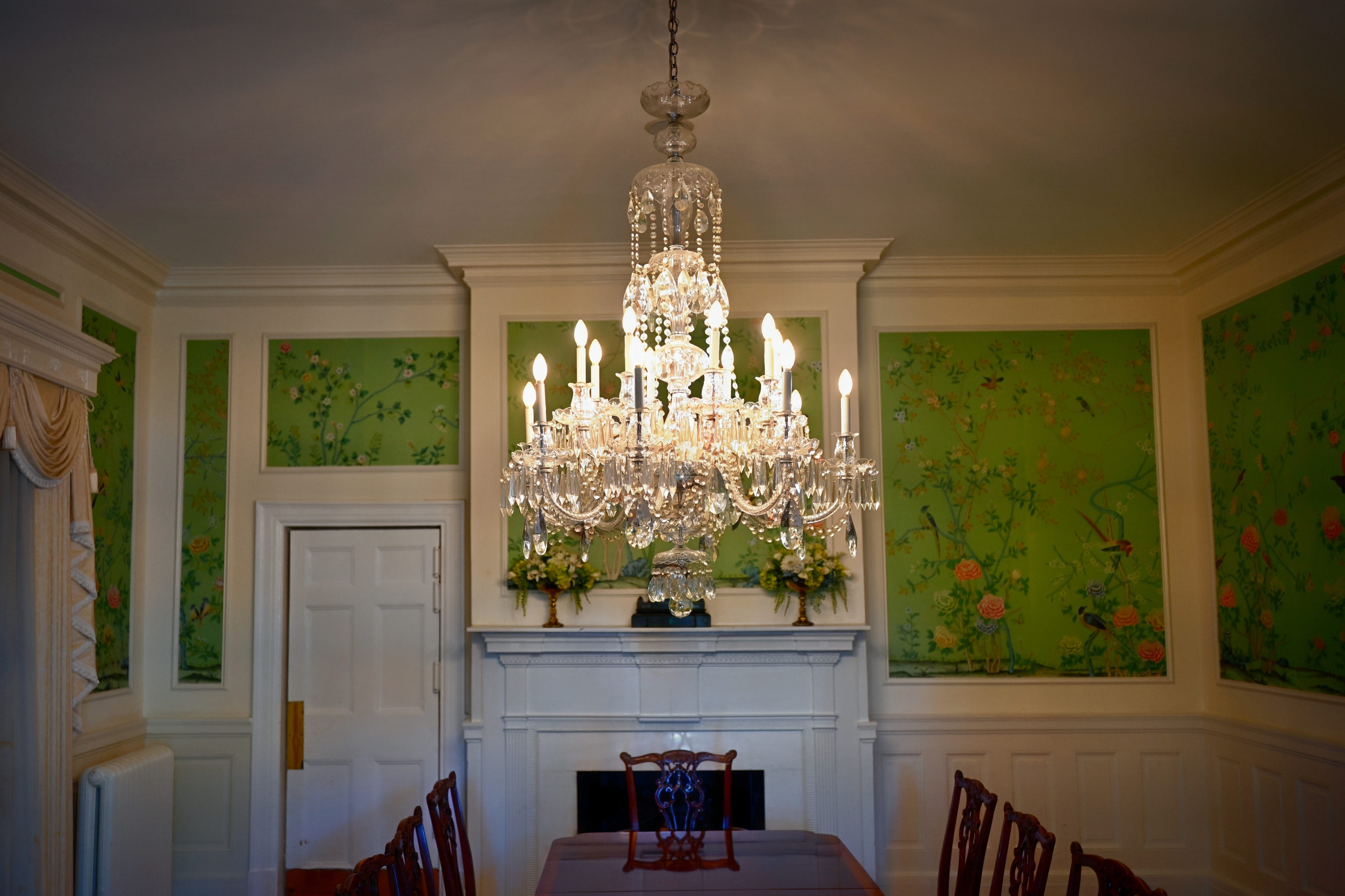 The formal dining room — its crystal chandelier and carved mantelpiece still presiding over the county's grandest gatherings.
