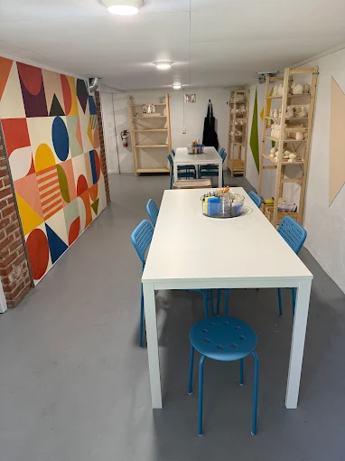 The Crawl Space studio interior with mural and work tables