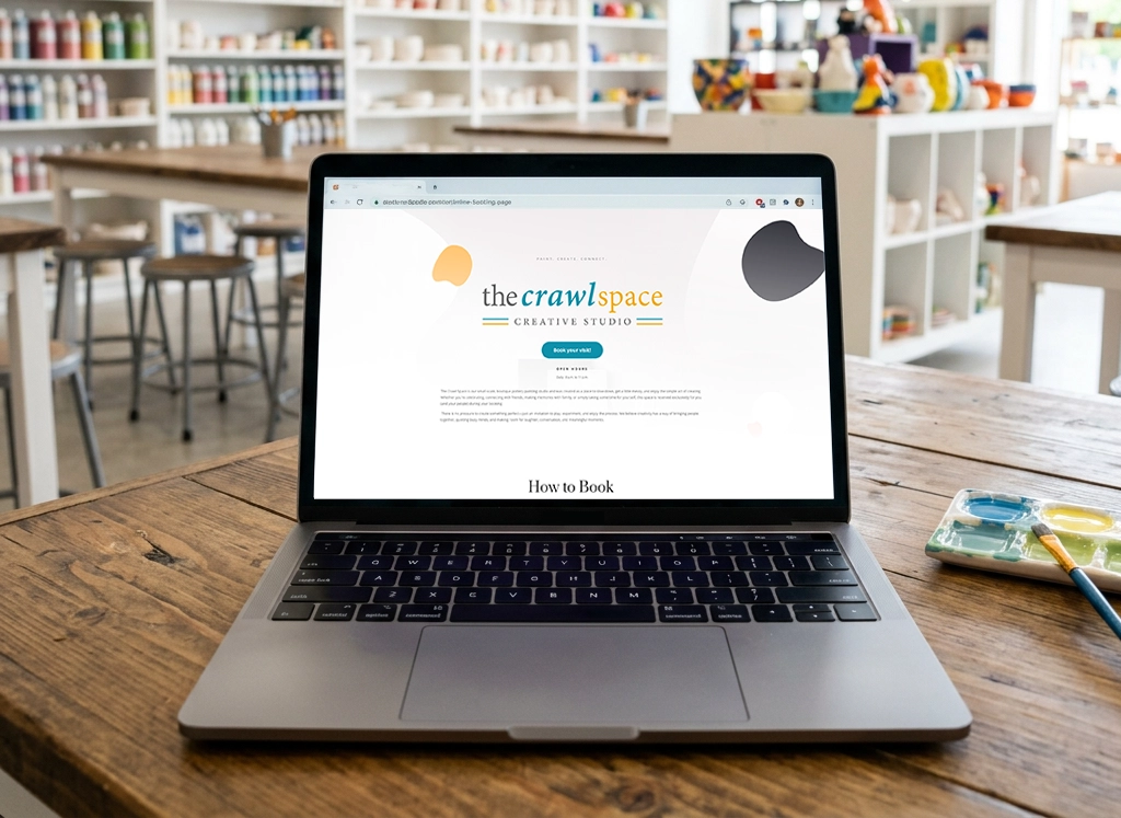 The Crawl Space Creative Studio website shown on a laptop