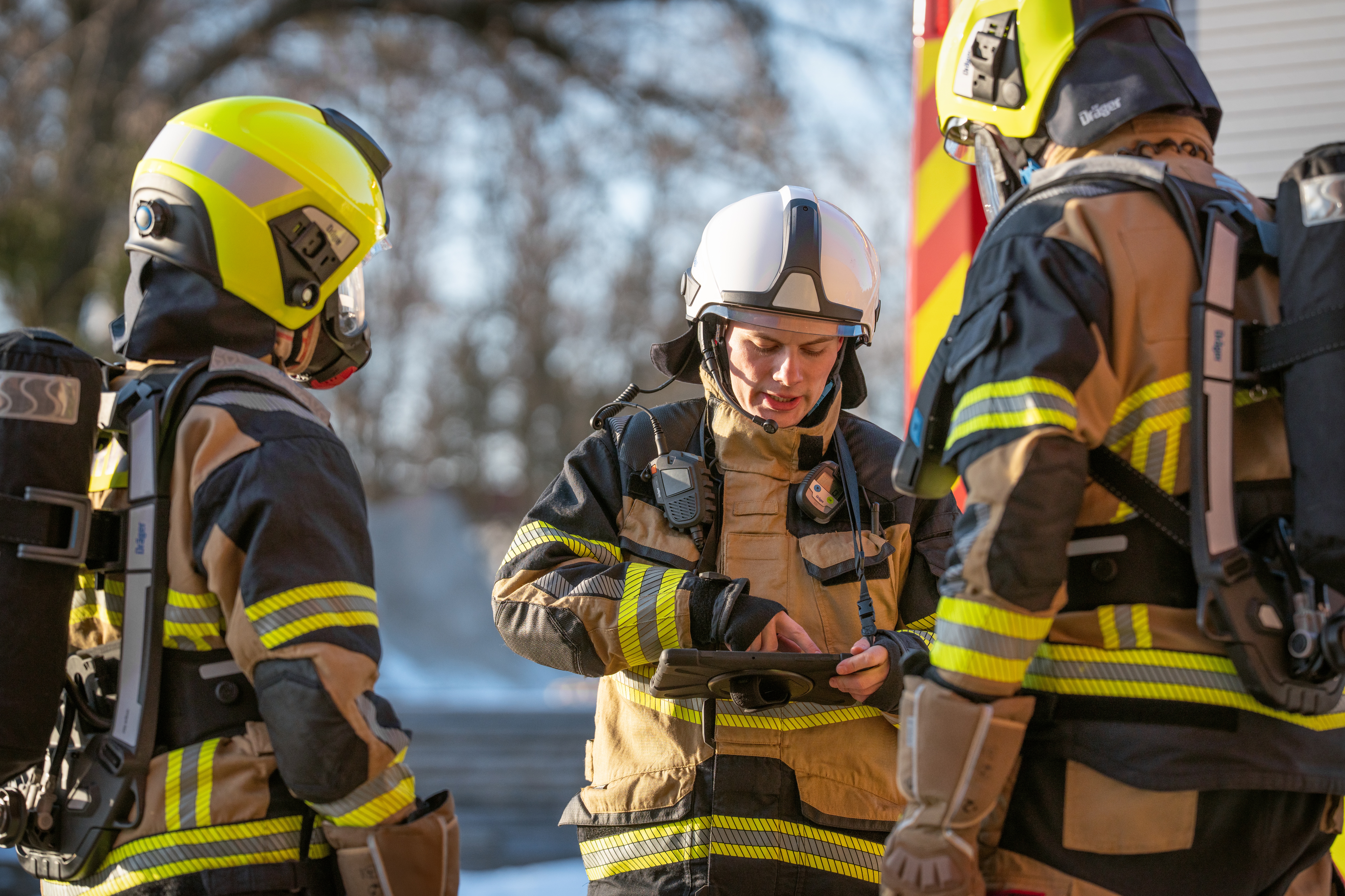 Firefighters assessing operations with Dräger equipment on the incident ground