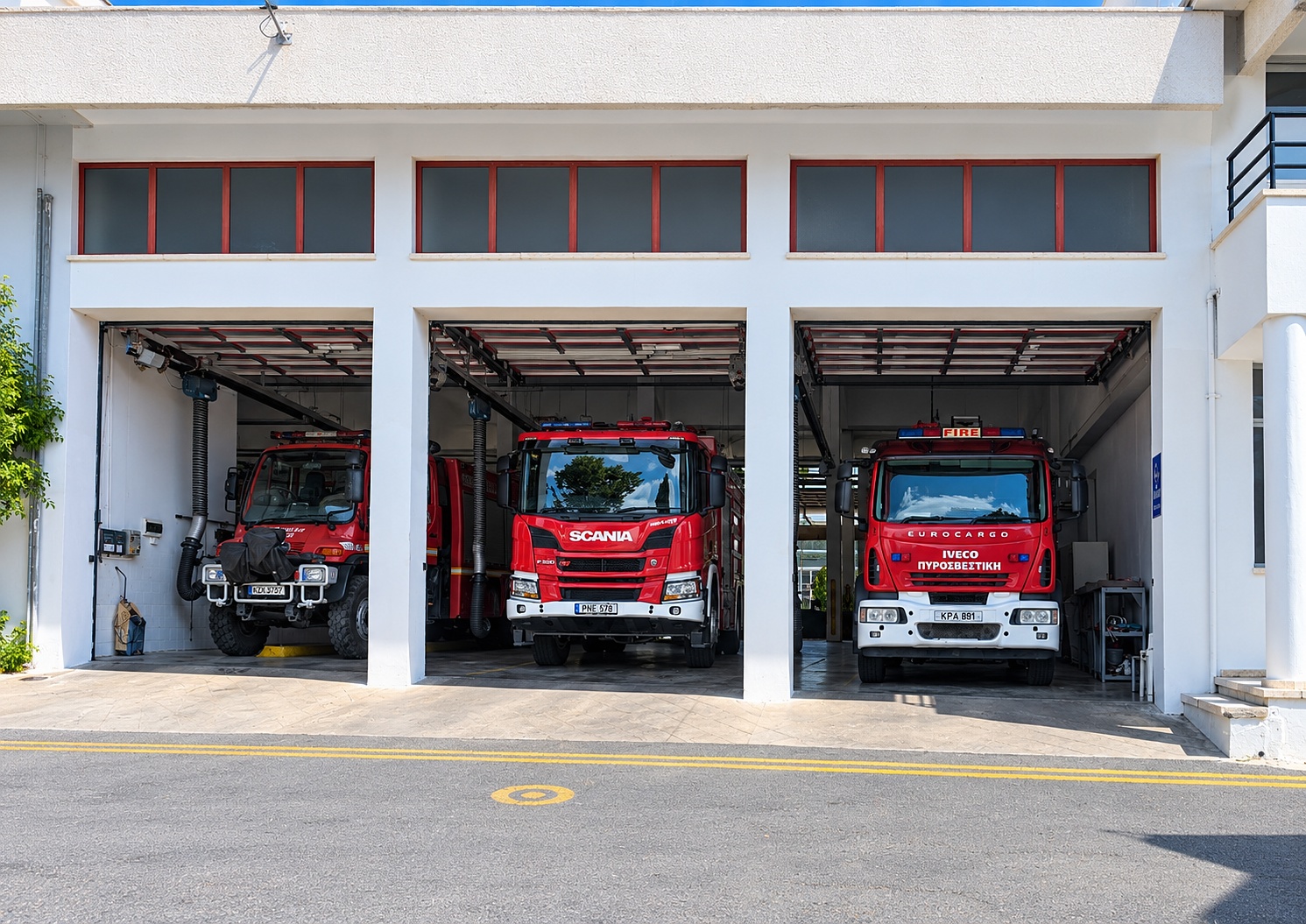 Three appliances lined up in the Paphos bay — a compact unit, a Scania and the Iveco Eurocargo.