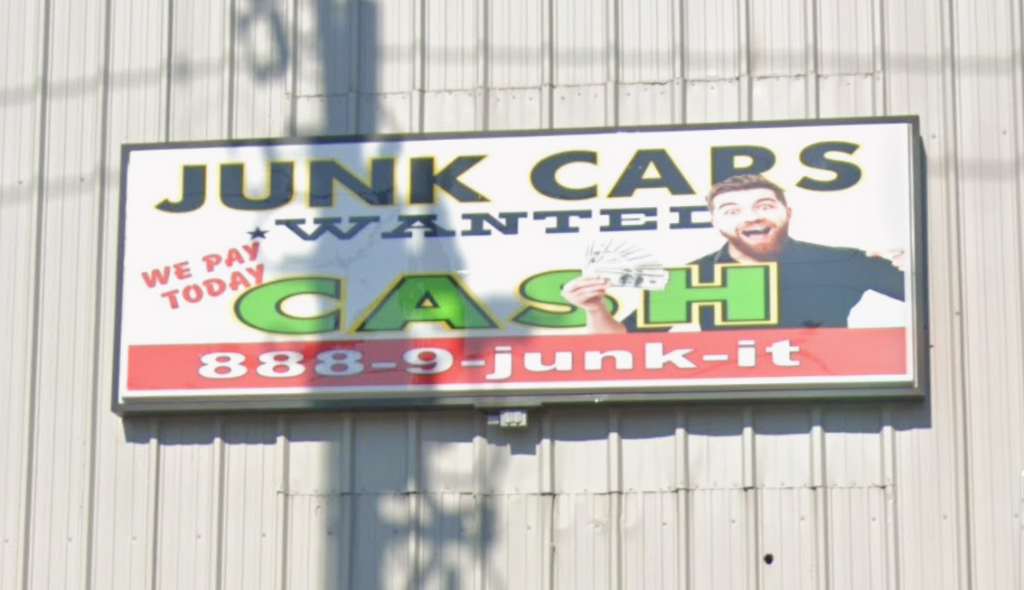 Junk Cars Wanted - We Pay Cash Today sign at our facility