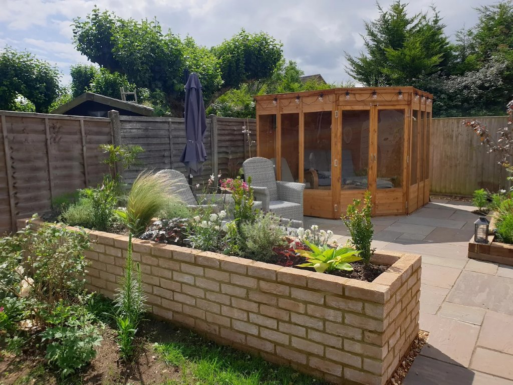 Garden with patio, raised brick beds and summerhouse built by Timmins Landscapes in Milton Keynes