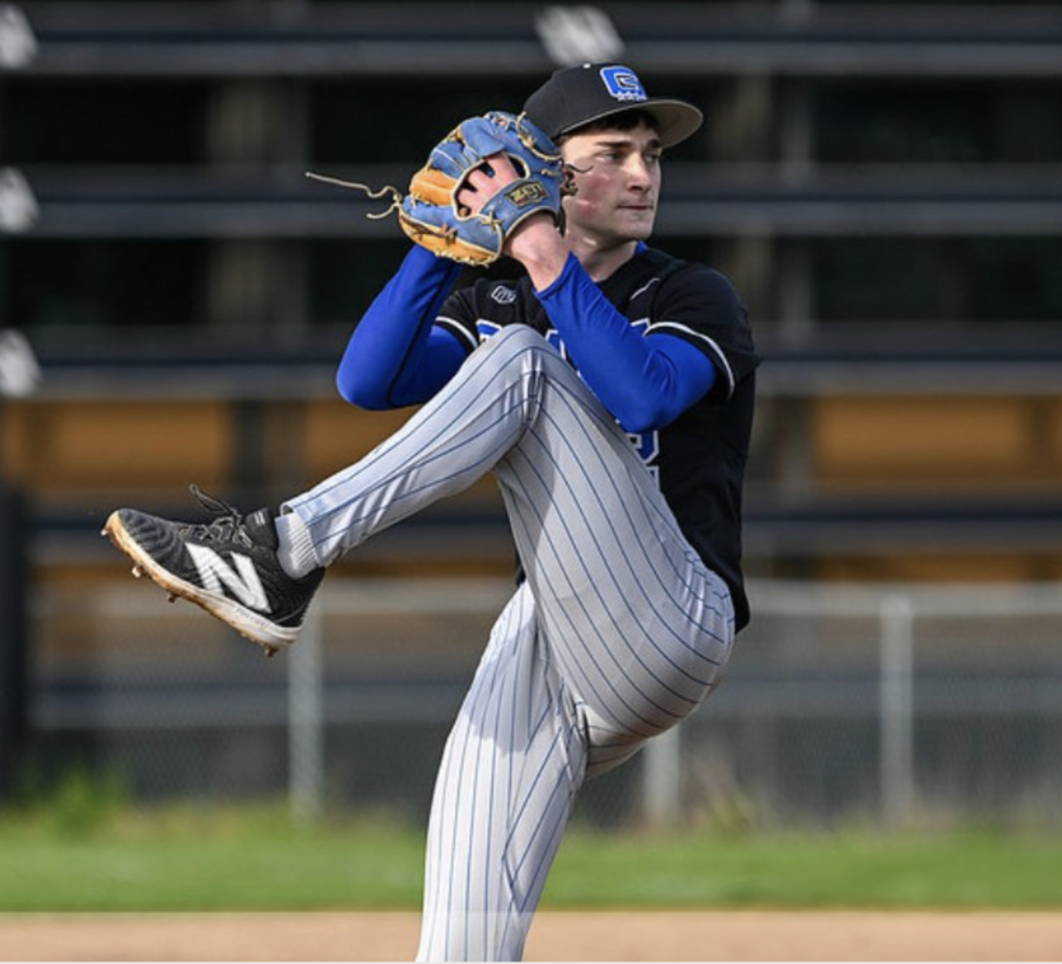 Youth pitcher in mid-delivery with perfect form