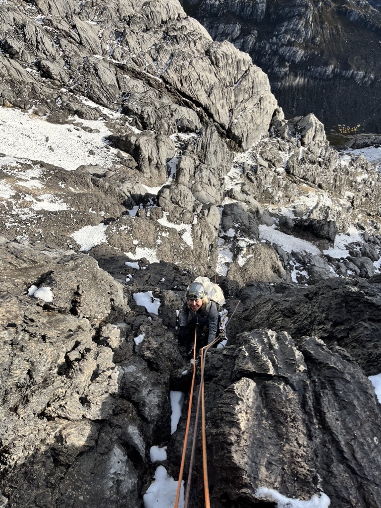 Guides and clients at remote Svalbard ridgeline above frozen Arctic fjord