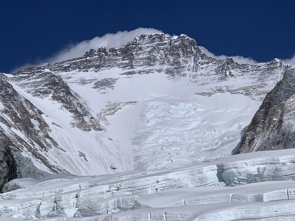 Guides and clients at remote Svalbard ridgeline above frozen Arctic fjord