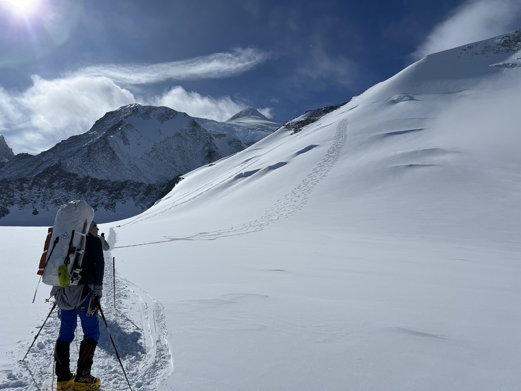 Guides and clients at remote Svalbard ridgeline above frozen Arctic fjord