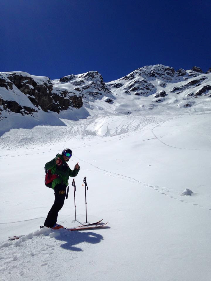 Ski touring group beneath dramatic rock spires in Svalbard Arctic wilderness