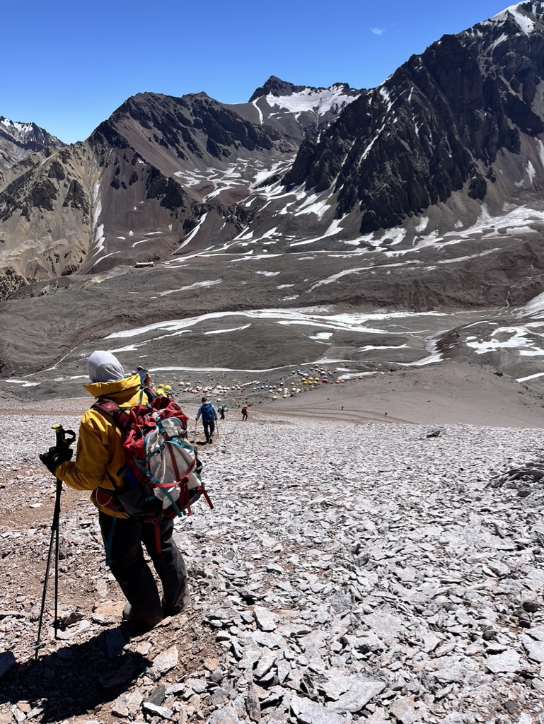 Skier making turns on corn snow with panoramic Arctic landscape, Svalbard
