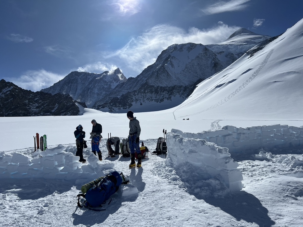 Skier making turns on corn snow with panoramic Arctic landscape, Svalbard