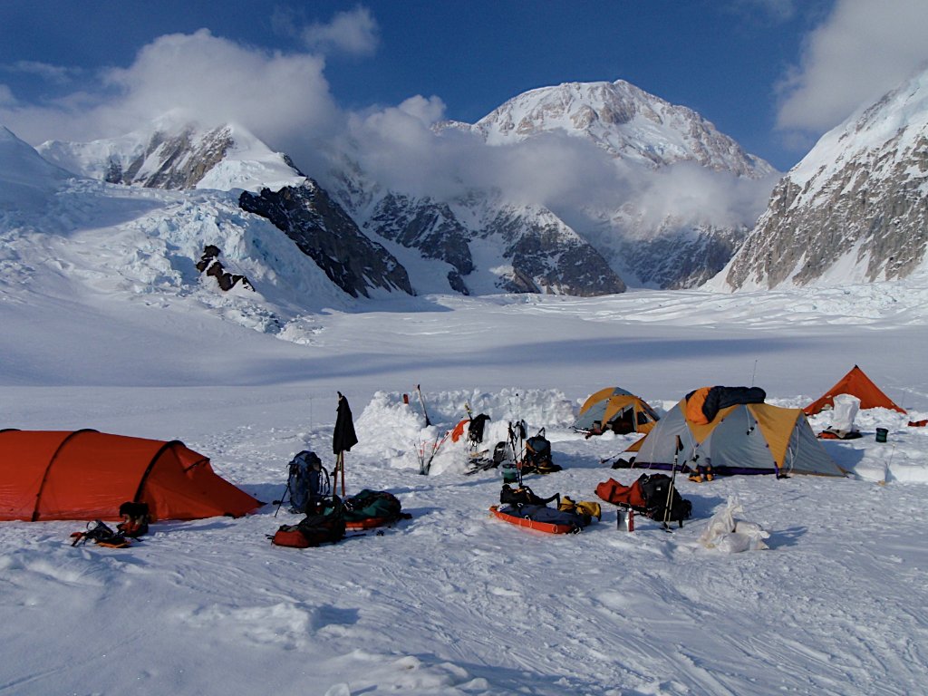 Guides and clients at remote Svalbard ridgeline above frozen Arctic fjord