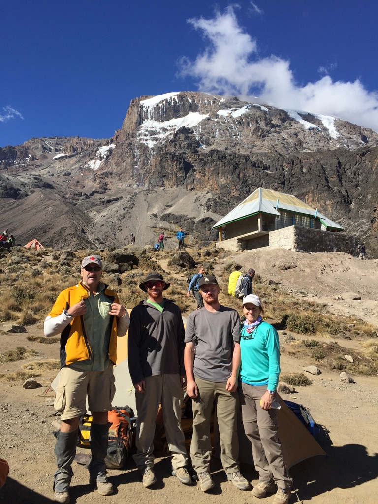 Guides and clients at remote Svalbard ridgeline above frozen Arctic fjord