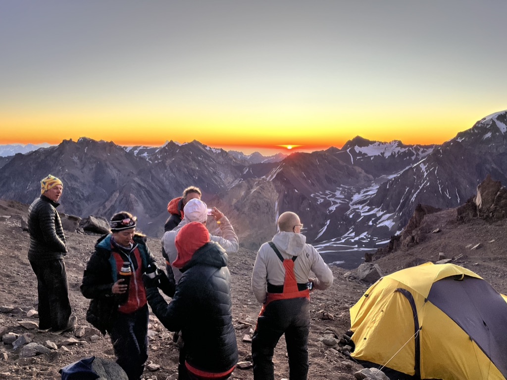 Guides and clients at remote Svalbard ridgeline above frozen Arctic fjord