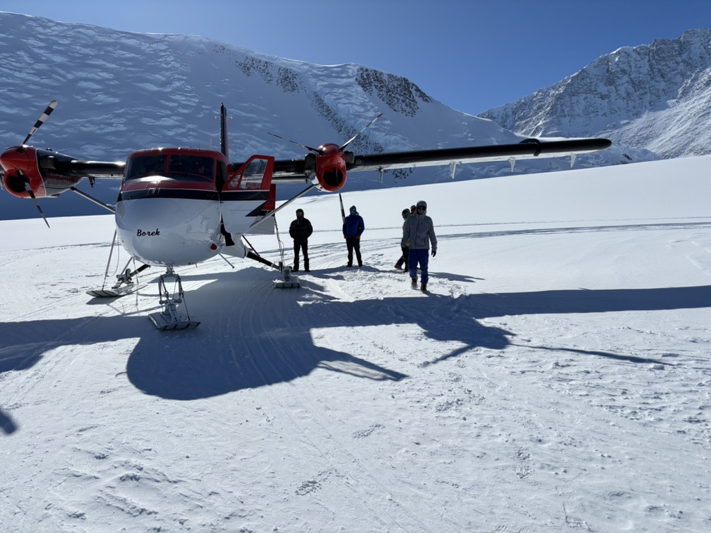 Group of skiers skinning above Arctic fjord on Ski Mt. Vinson — Antarctica expedition, Svalbard Norway