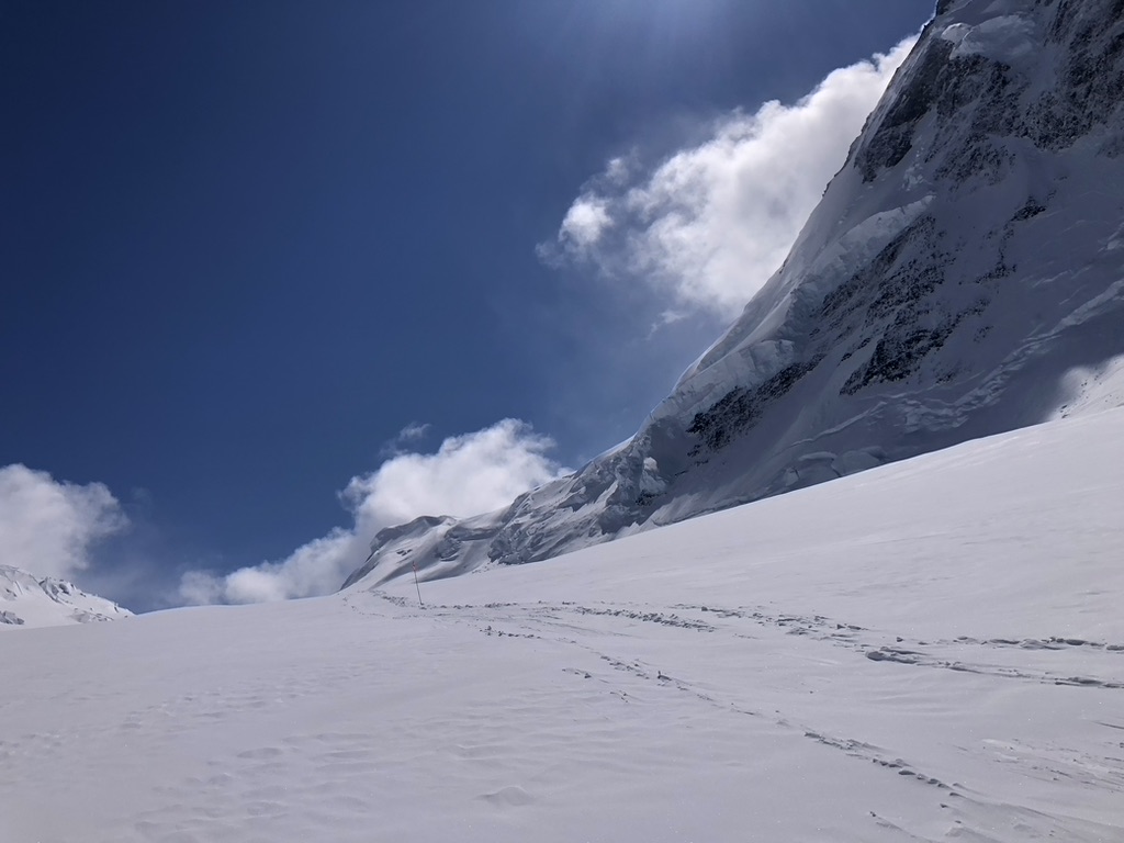Ski touring group beneath dramatic rock spires in Svalbard Arctic wilderness