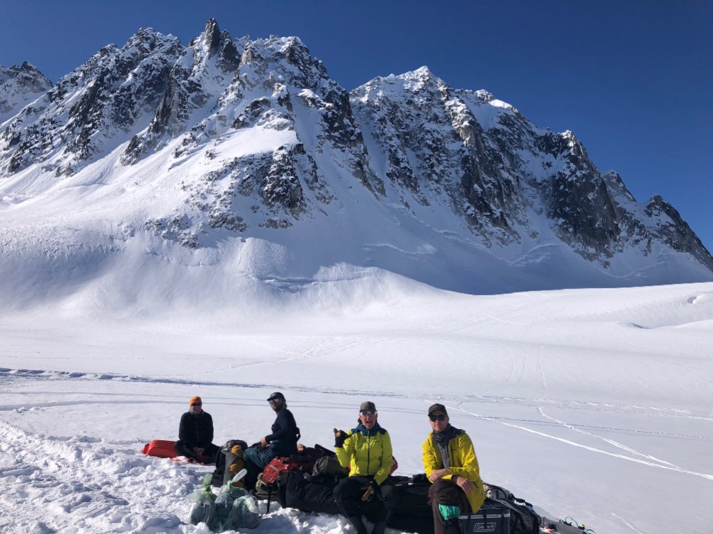 Group of skiers skinning above Arctic fjord on Alaska Range Basecamp Ski Week expedition, Svalbard Norway