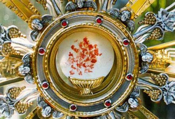 A consecrated host with visible blood markings enshrined in a golden monstrance