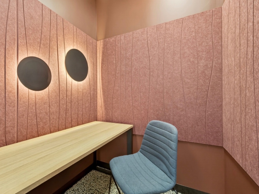 Intimate boardroom pod — leather seating, dark acoustic panels