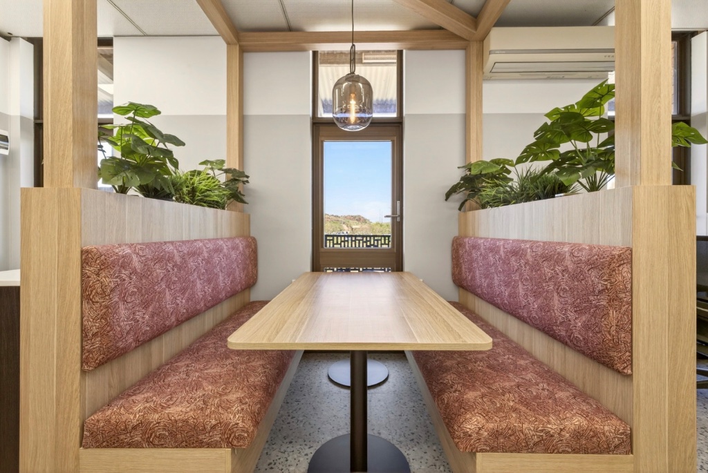Hot-desk zone with timber frame pergola and pendant lighting