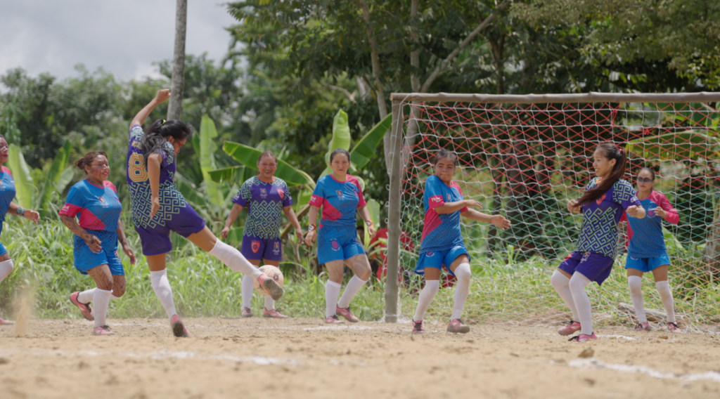 Indigenous youth playing football in the Amazon