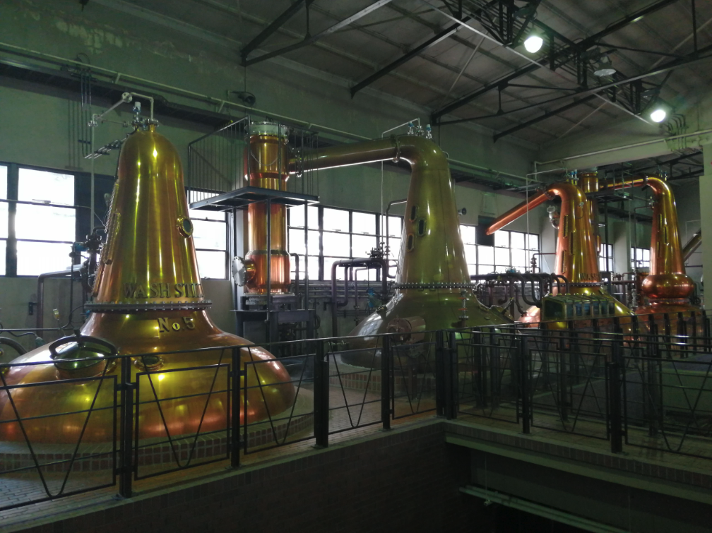 Copper pot stills inside a Japanese whisky distillery