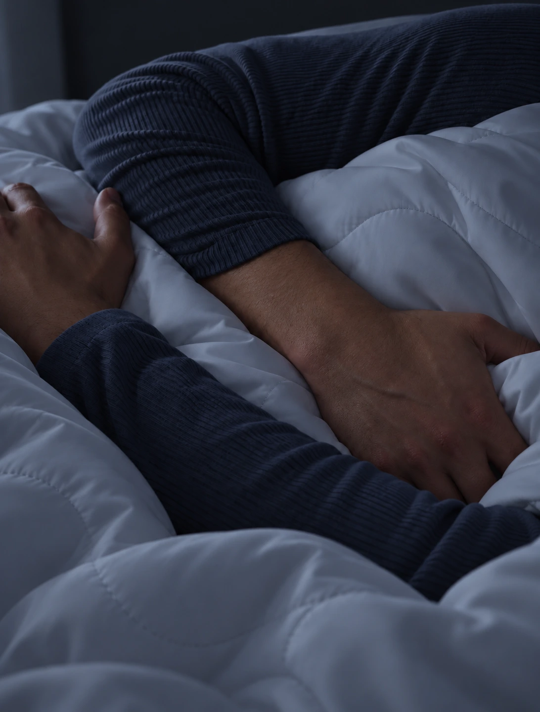 A person sleeping naturally on a Sleep Lab pillow, with relaxed posture and softly arranged bedding