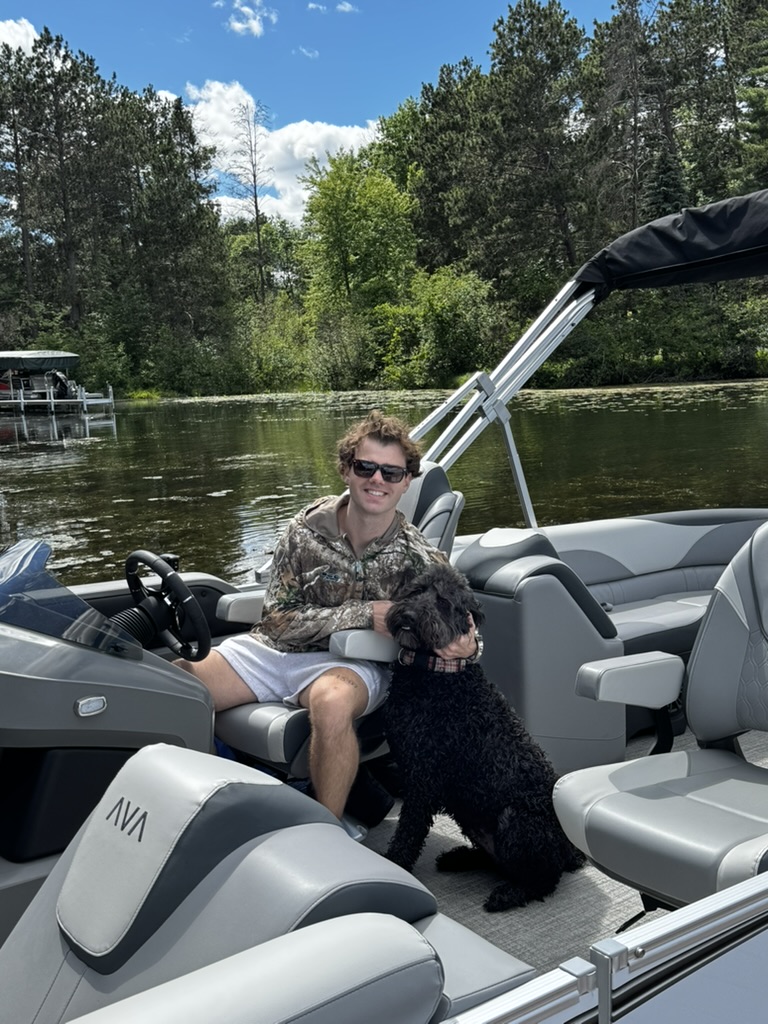 Enjoying a day on the water with a furry friend aboard a Whitefish Rentals pontoon