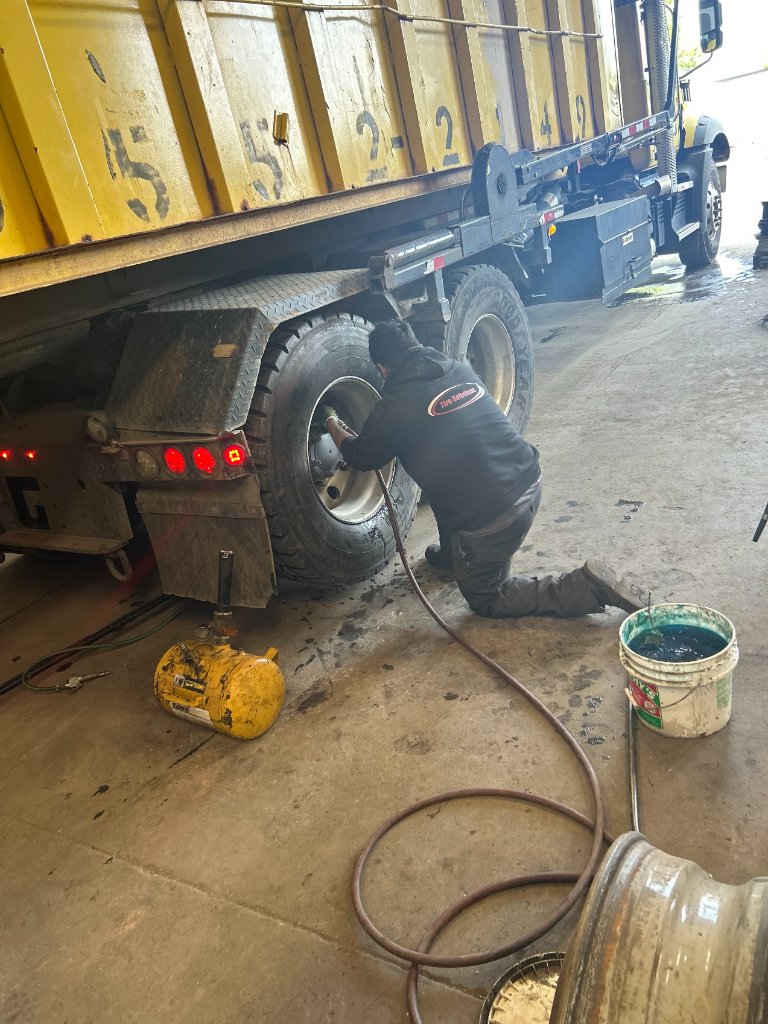 Tire Solutions technician performing commercial tire repair