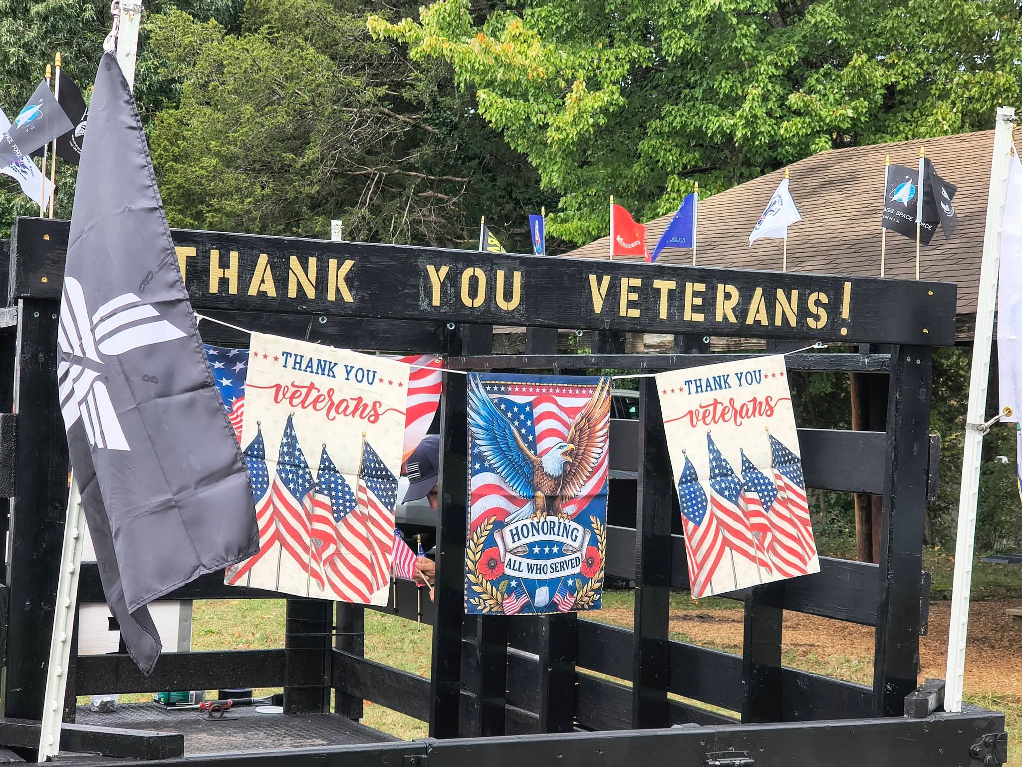 Thank You Veterans sign with banners hung across the float
