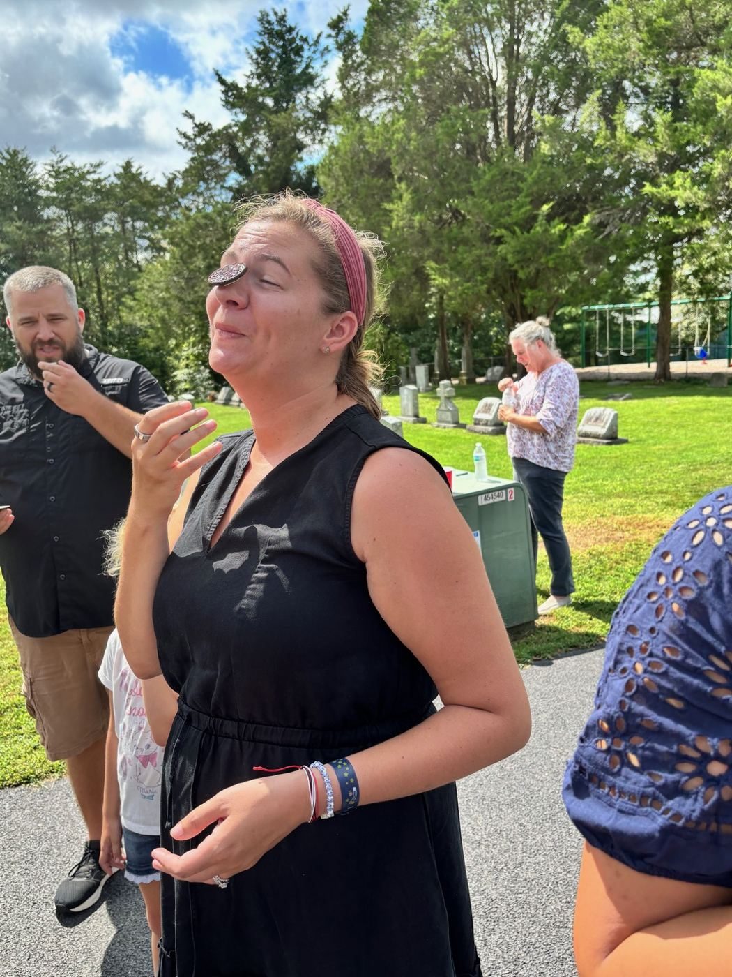 Woman with an Oreo balanced on her forehead