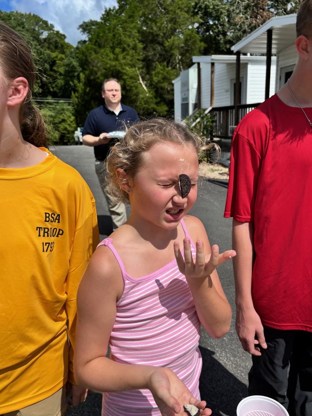 Girl with an Oreo balanced on her forehead