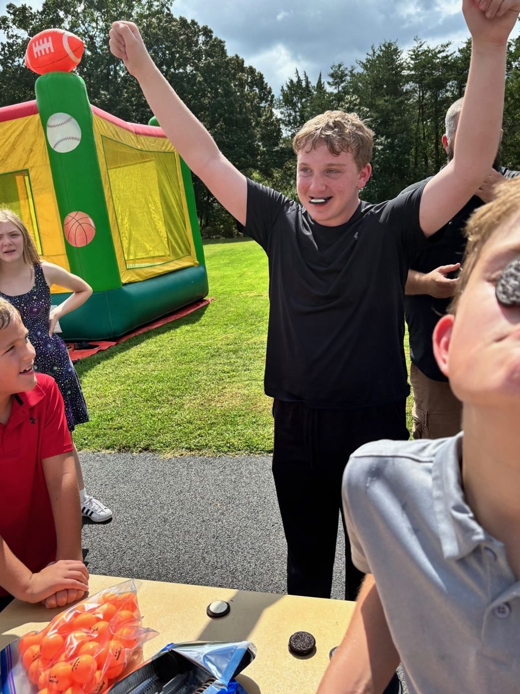 Teen celebrates with an Oreo cookie between his teeth