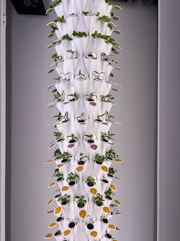 Vertical tower garden with multiple seed pods growing