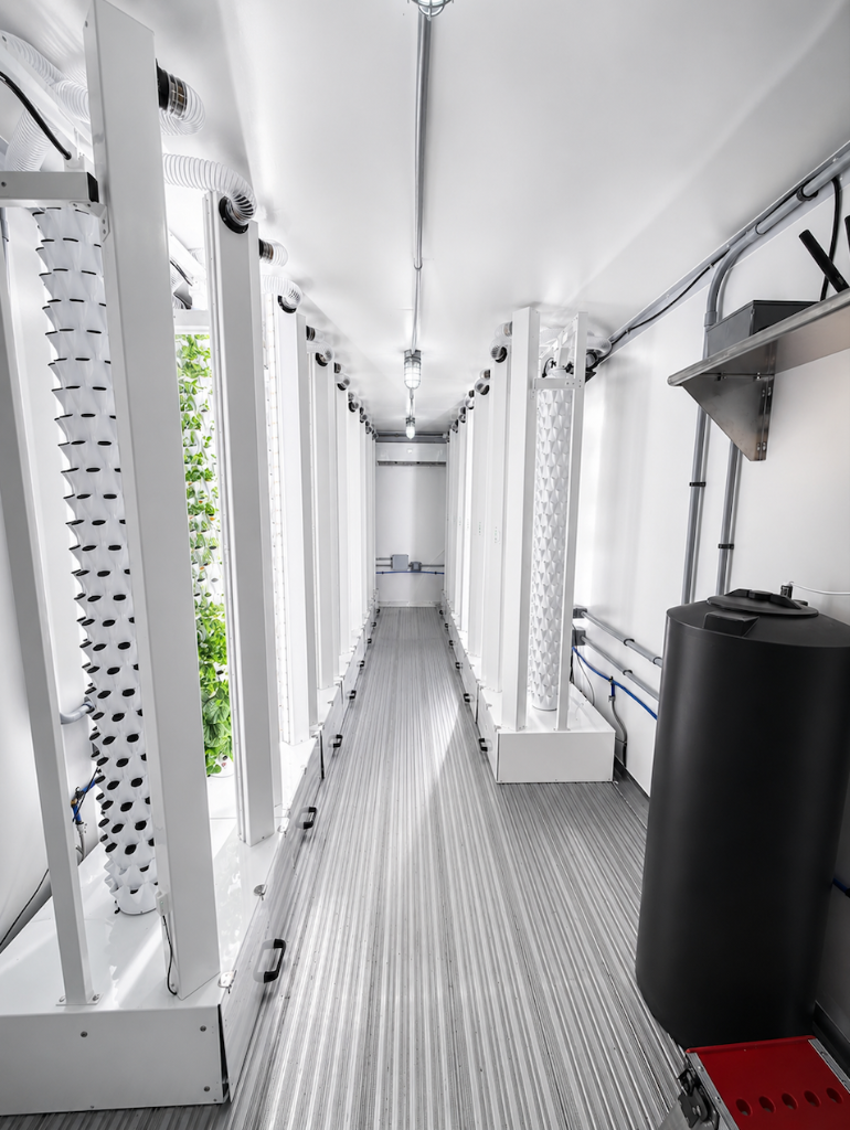 Container farm interior with vertical grow towers