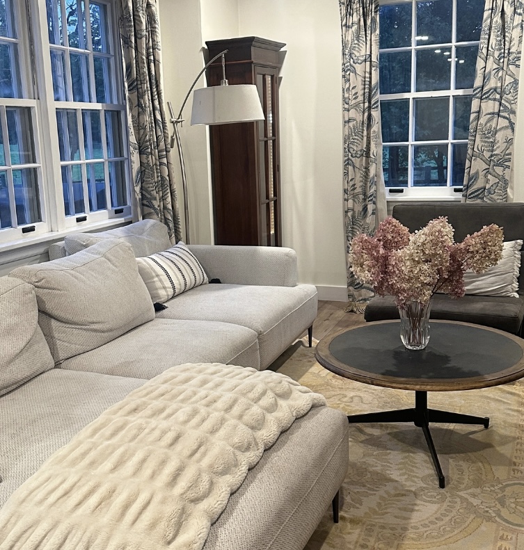 Cozy, freshly cleaned living room with a light-grey sectional sofa