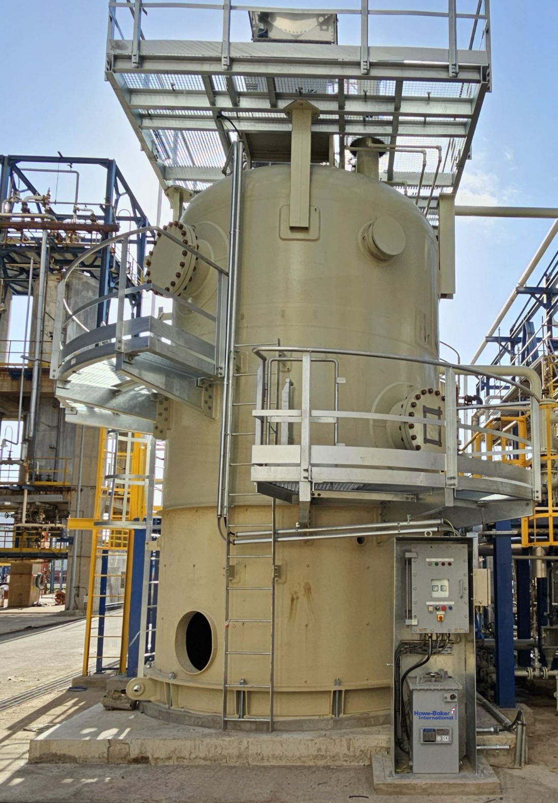 Vertical DC electrostatic coalescer at Aspropyrgos Refinery, Hellenic Energy, Greece — power unit and local control panel at grade, high-voltage bushing and transformer on the top platform