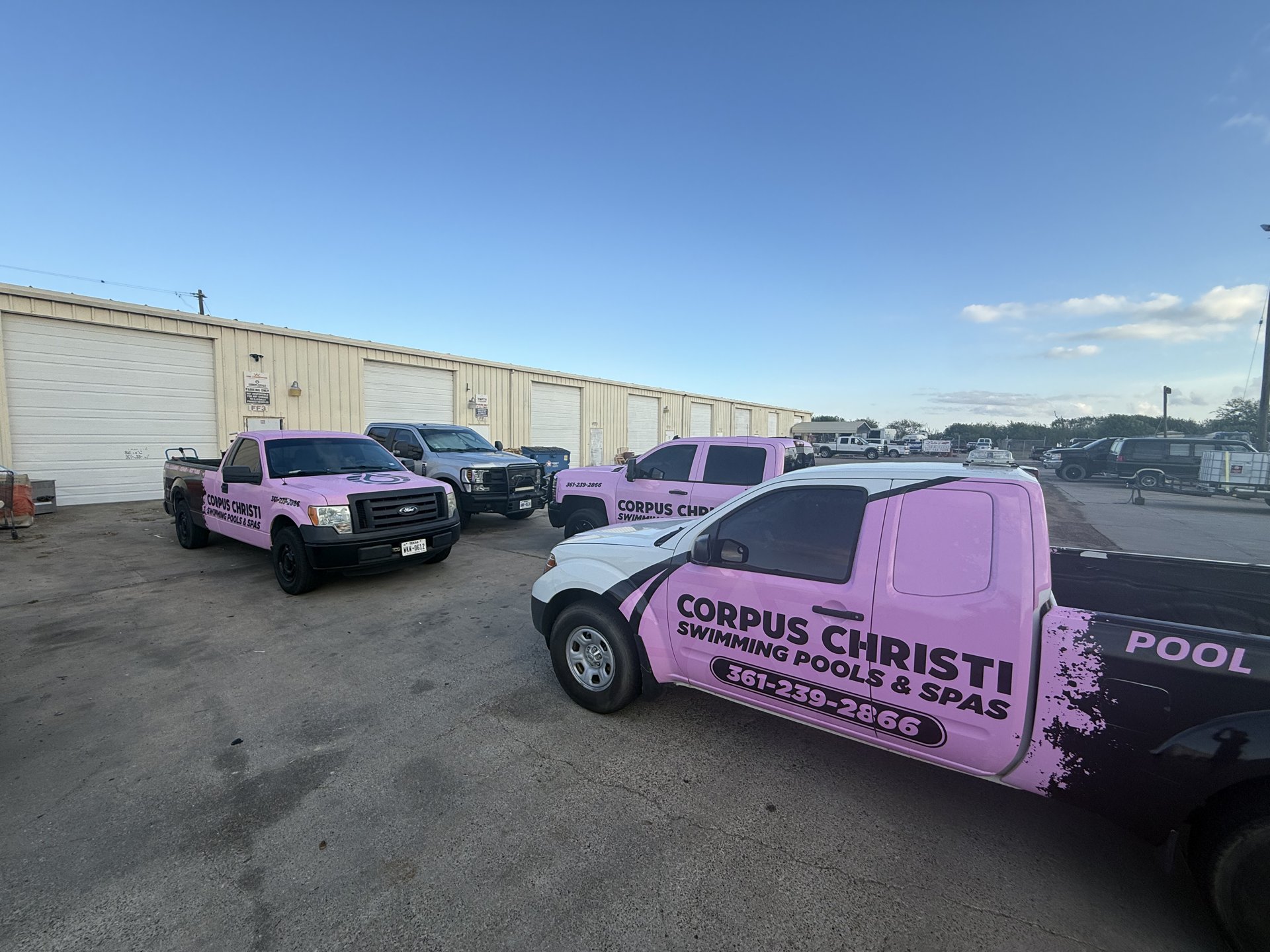 Corpus Christi Swimming Pools & Spas pink and black service trucks parked together in Corpus Christi