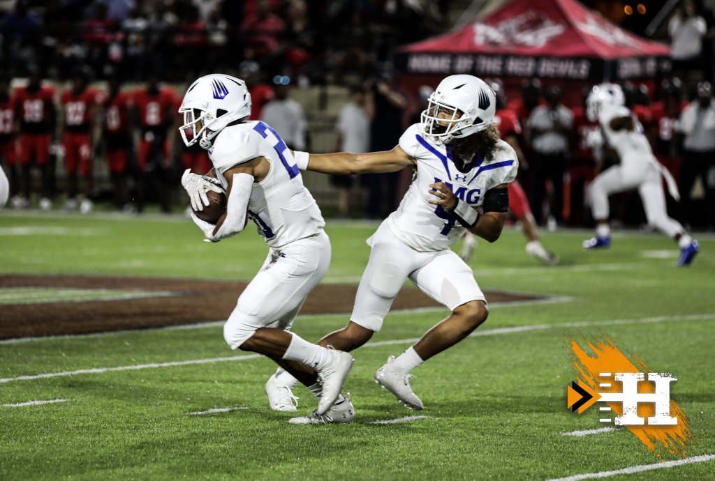 IMG Academy — IMG QB hands off under the lights