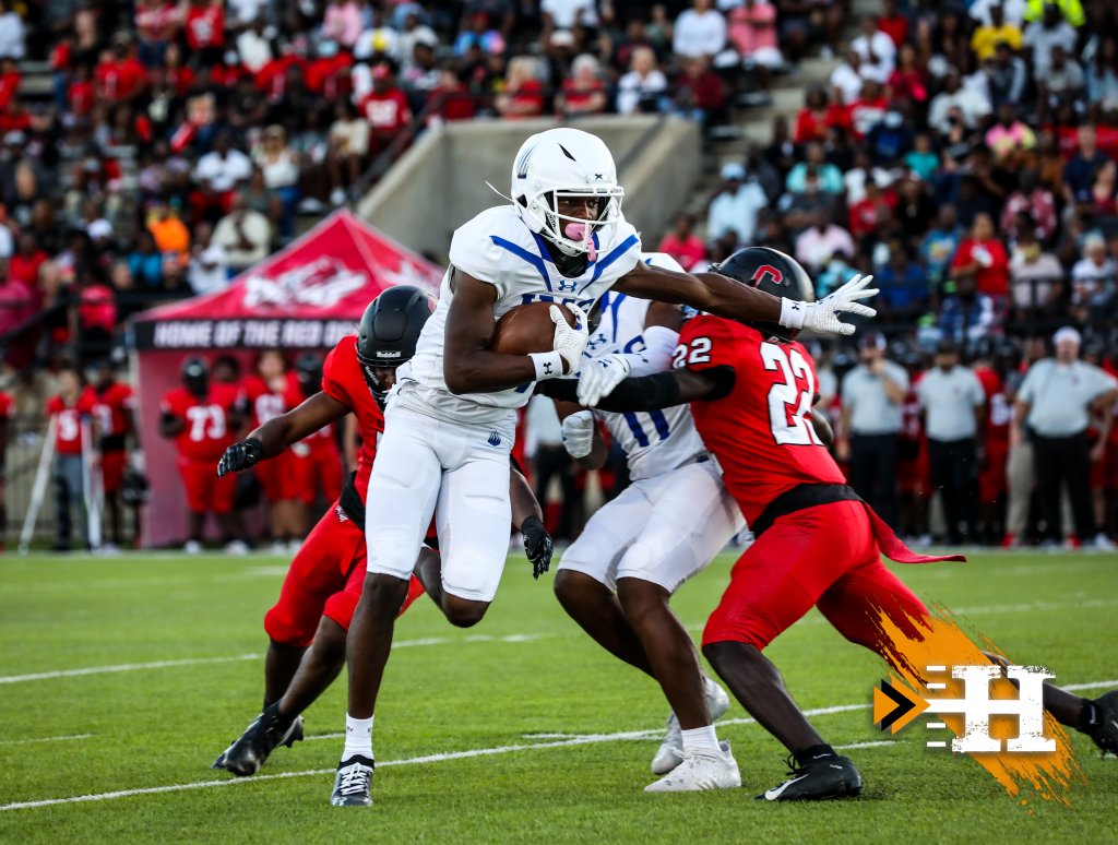 IMG Academy — IMG RB stiff-arms the defender through the crowd