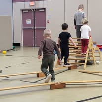 Children using climbing equipment in the gymnasium