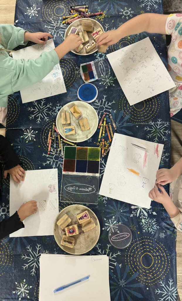 Children stamping and creating art at the table