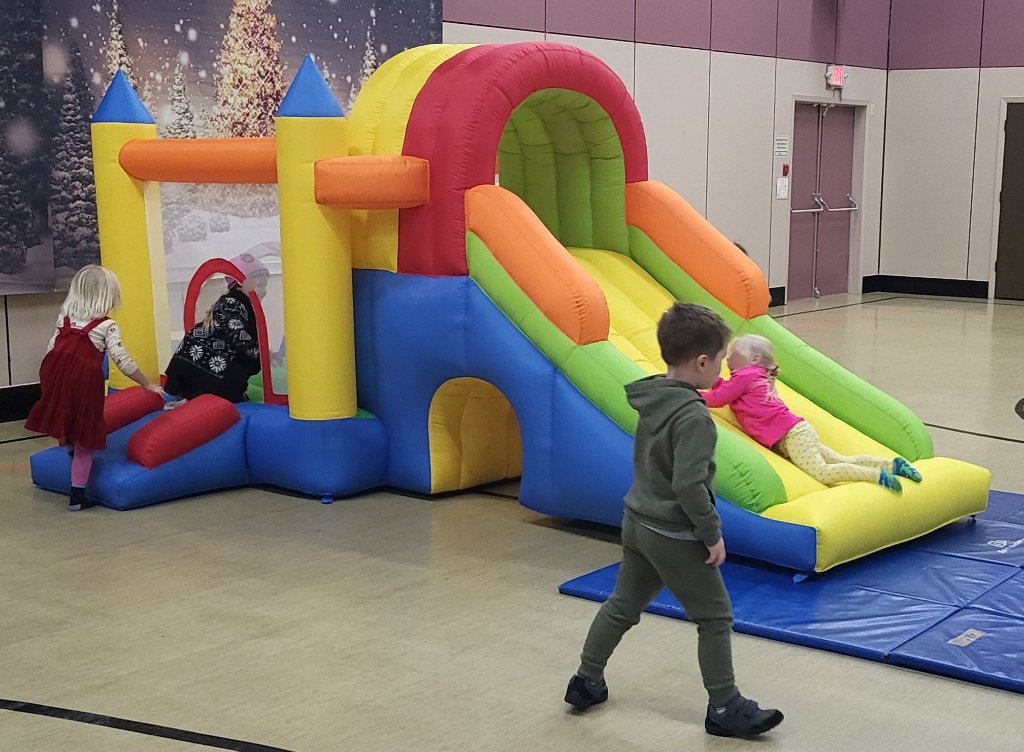 Children playing on a bounce castle in the gymnasium