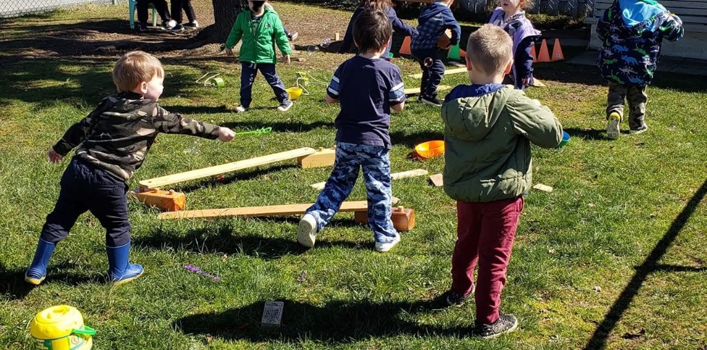 Children balancing on outdoor balance beams
