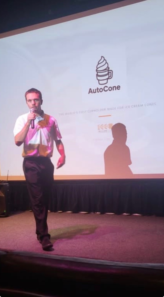 Brody Meltzer, founder of AutoCone, presenting on stage