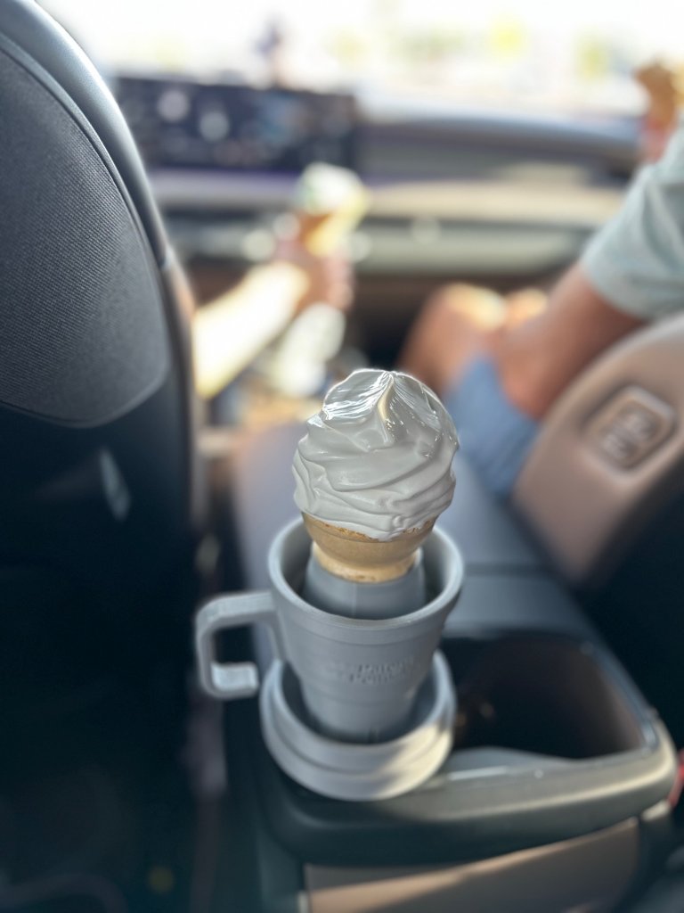 Clean car interior with AutoCone holding an ice cream cone perfectly upright in the cupholder